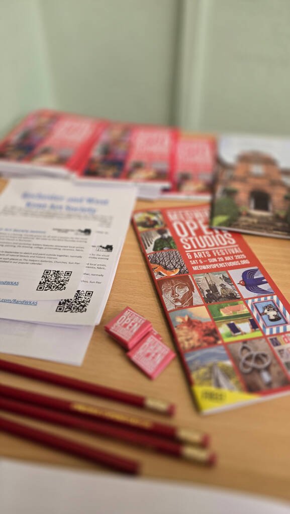 Close-up of Aliya Bodnar’s postcards, flyers, and packaging materials at Medway Open Studios 2025, showcasing branding and artistic details.