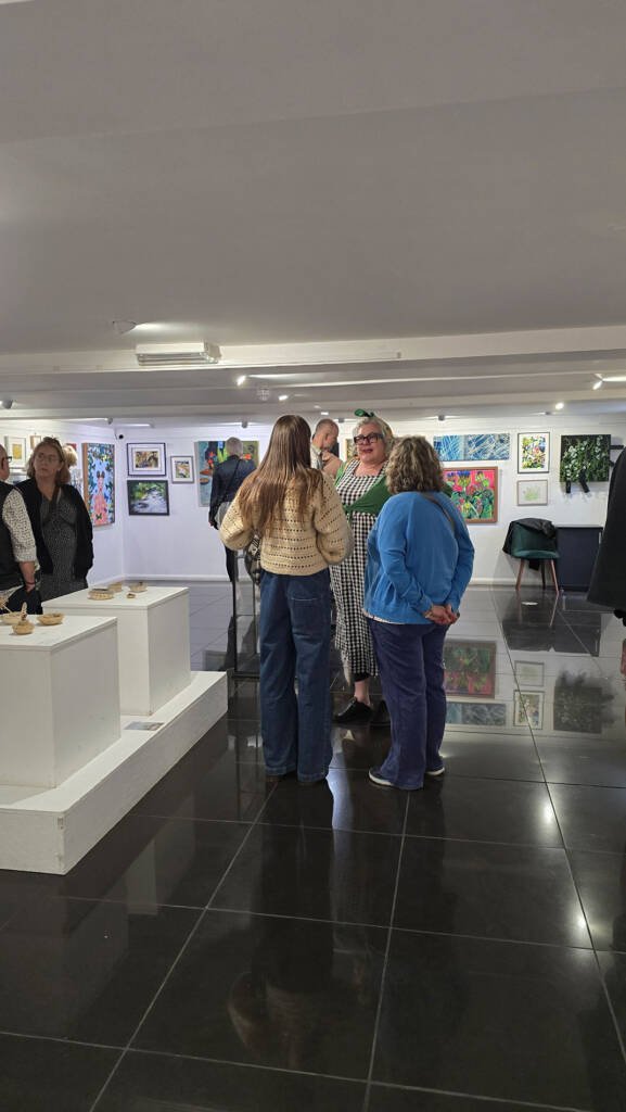 Visitors interacting and viewing artworks at Aliya Bodnar’s Summer Exhibition 2025 in Chatham.