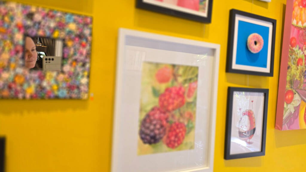 Artist Aliya Bodnar standing beside her watercolour “Blackberries from the Garden” at the TASTE group exhibition in Medway, 2025.