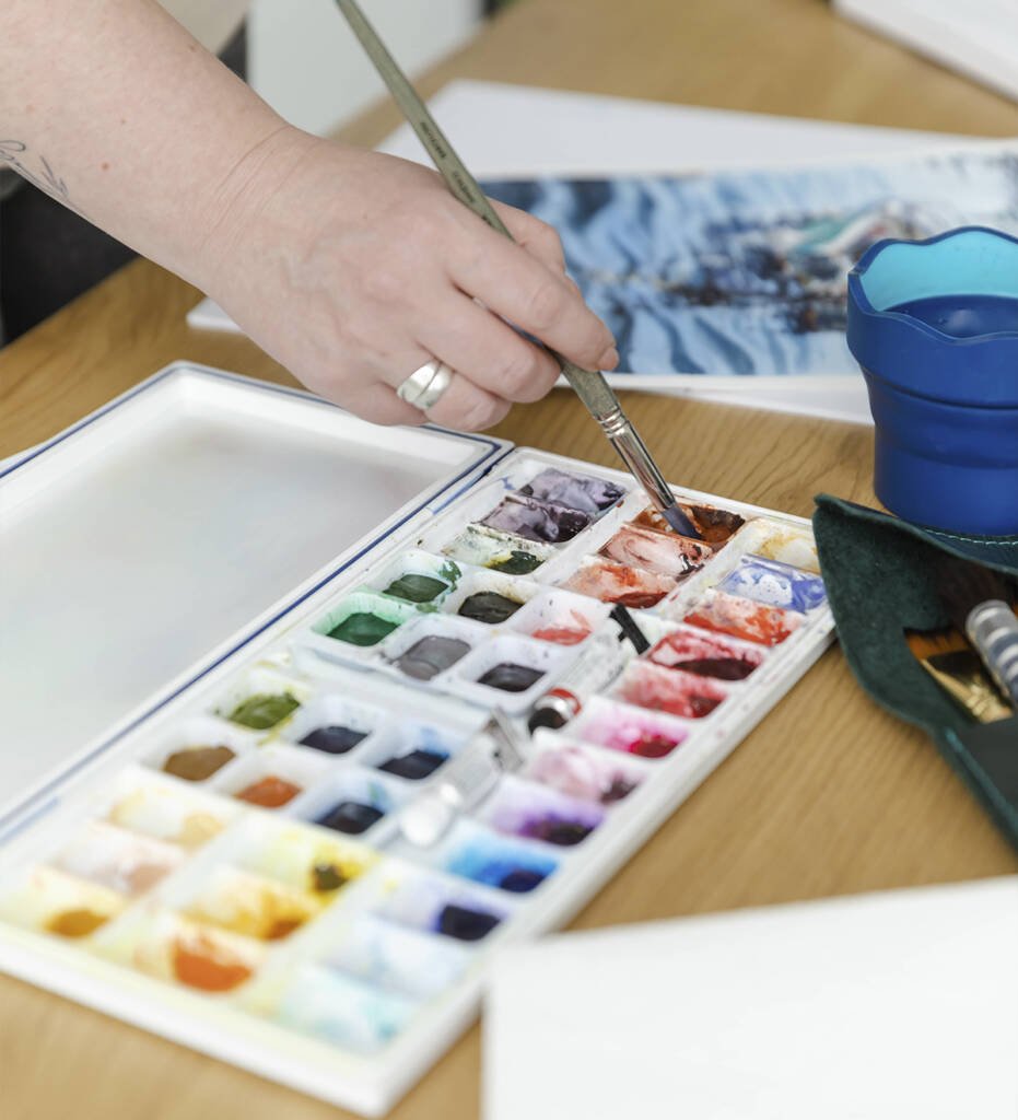 Watercolor palette with mixed pigments in Aliya Bodnar’s art studio.