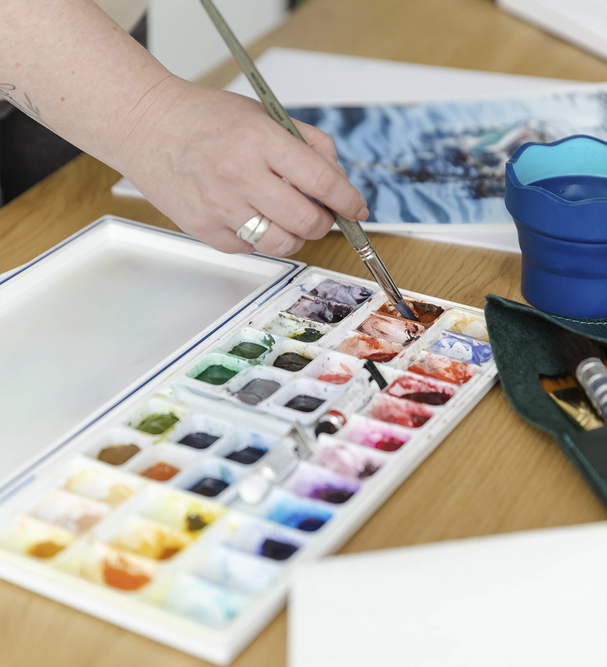 Watercolor palette with mixed pigments in Aliya Bodnar’s art studio.