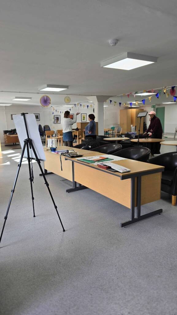 View of the classroom setup before Aliya Bodnar’s sunflower watercolor workshop, showing easels and arranged materials.