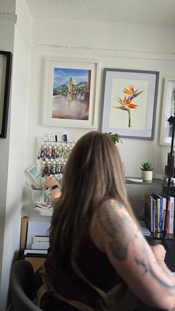 Aliya Bodnar working in her home art studio, surrounded by natural light and creative stillness.
