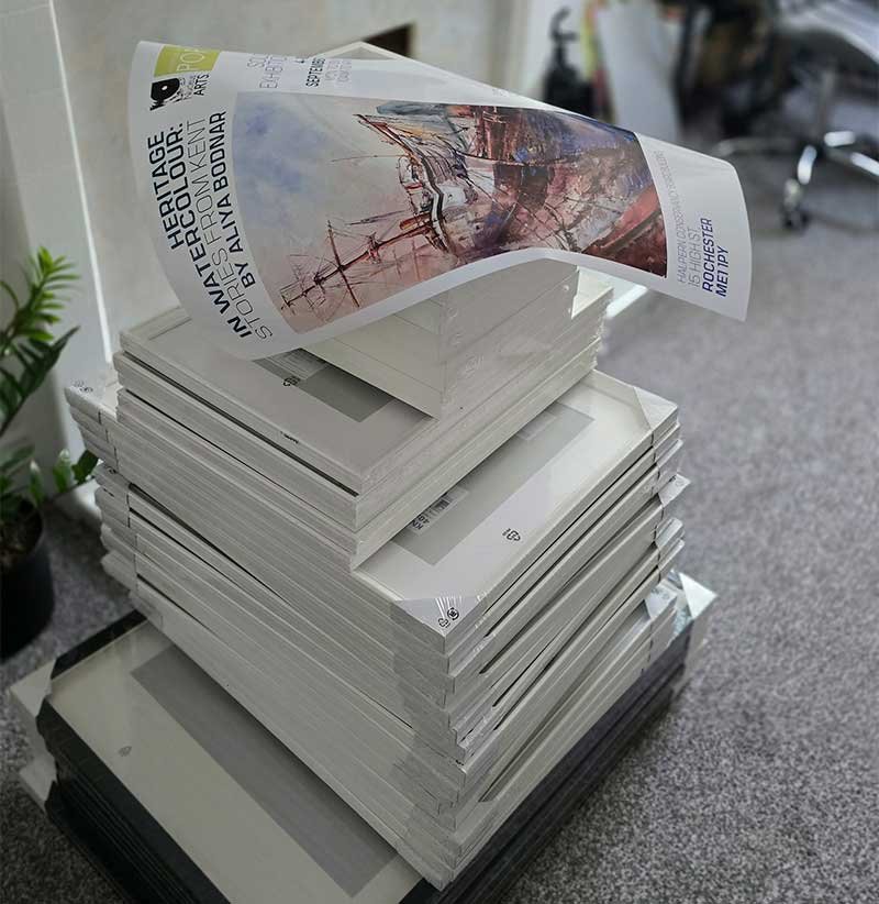 Stack of framed watercolour paintings prepared by artist Aliya Bodnar for her solo exhibition in Rochester.