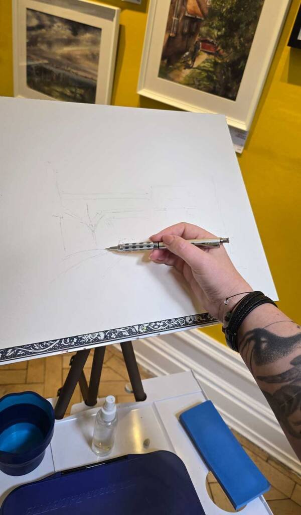 Artist Aliya Bodnar sketching live during her solo watercolour exhibition in Rochester, 2025.