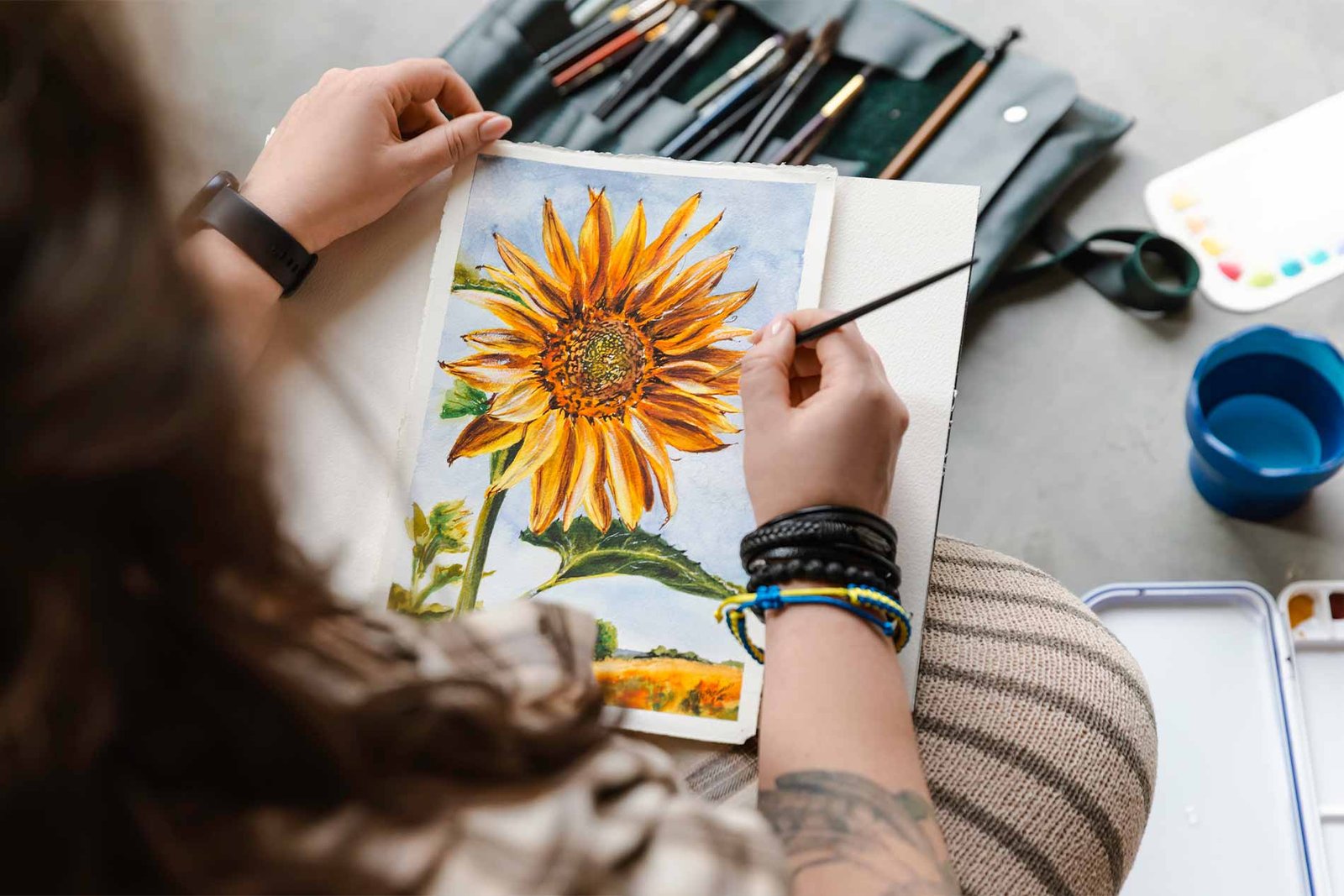 Artist painting a sunflower in a creative studio while reflecting on purpose, creativity, and the deeper meaning behind making art.